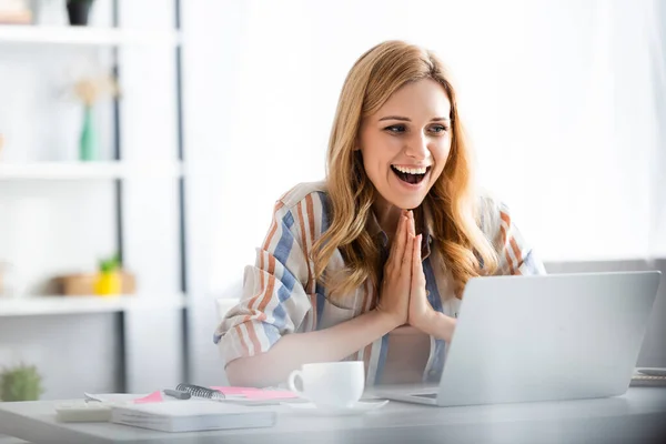 Selective focus of pretty woman laughing and smiling during webinar — Stock Photo