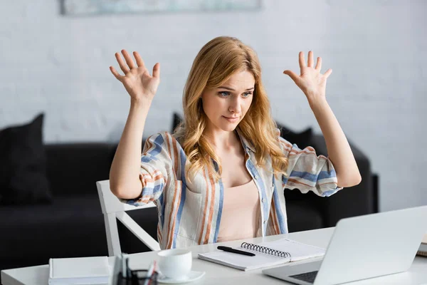 Selective focus of woman showing hands in front of laptop — Stock Photo