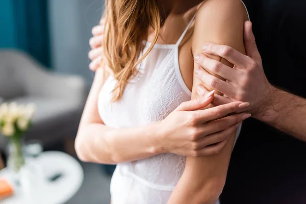 Cropped view of man hugging seductive woman at home — Stock Photo