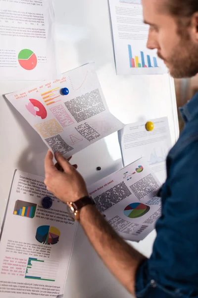 Selective focus of charts and graphs in hand of businessman — Stock Photo