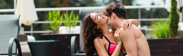 Panoramic shot of woman with closed eyes hugging shirtless man — Stock Photo