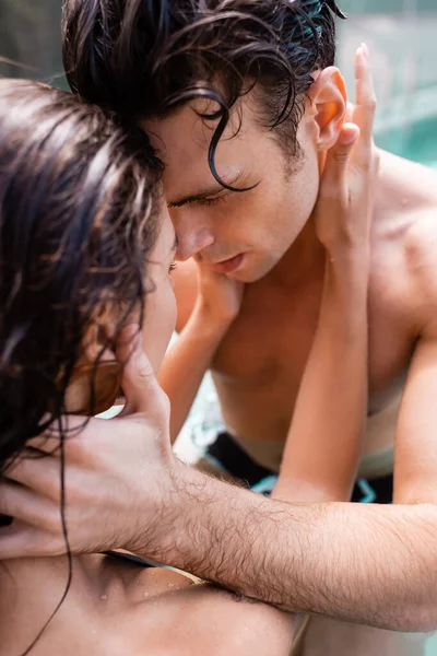 Selective focus of woman touching shirtless man — Stock Photo