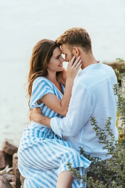 Happy woman hugging and looking at handsome boyfriend — Stock Photo