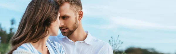 Cultivo panorámico de hombre barbudo mirando a su novia fuera - foto de stock