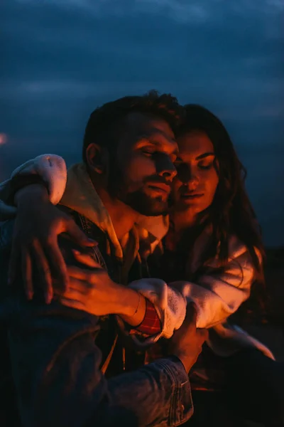 Attractive woman hugging handsome man at night — Stock Photo