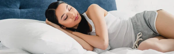 Panoramic orientation of young asian woman sleeping on bed — Stock Photo