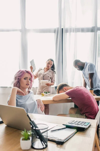 Selective focus of multicultural business people feeling hot while working in office — Stock Photo