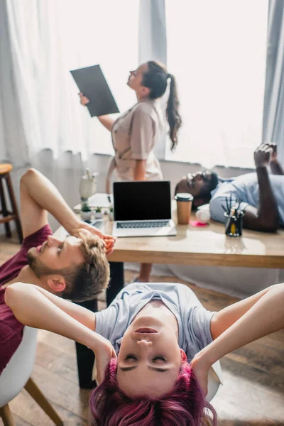 Selective focus of four multicultural business people feeling hot in office — Stock Photo