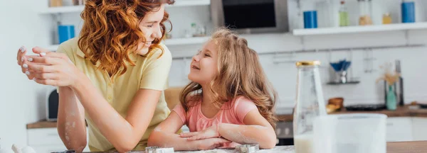 Focus selettivo di mamma e figlia che si guardano mentre cucinano in cucina — Foto stock