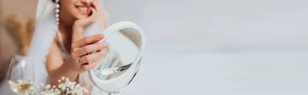 Plan panoramique de mariée en voile touchant miroir près des fleurs et un verre de vin — Photo de stock