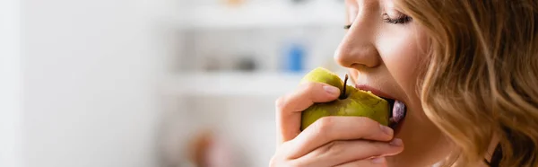 Plan panoramique de femme aux yeux fermés mangeant de la pomme — Photo de stock