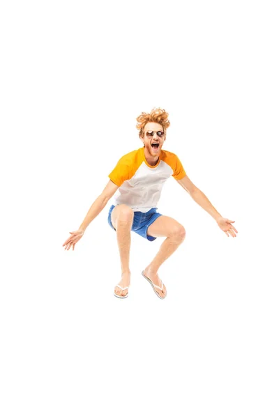 Excited man in flip flops and sunglasses jumping isolated on white — Stock Photo