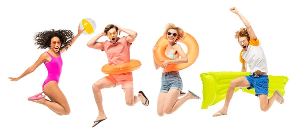 Panoramic shot of multicultural friends with inflatable mattress and ball jumping isolated on white — Stock Photo