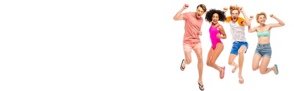 Panoramic shot of multicultural friends in sunglasses and swimsuits showing yeah gesture while jumping isolated on white — Stock Photo