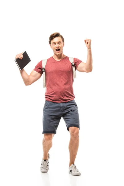 Student holding notebook and showing yeah gesture on white background — Stock Photo