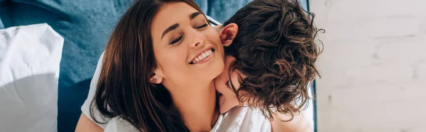 Panoramic crop of man embracing and kissing girlfriend in neck — Stock Photo