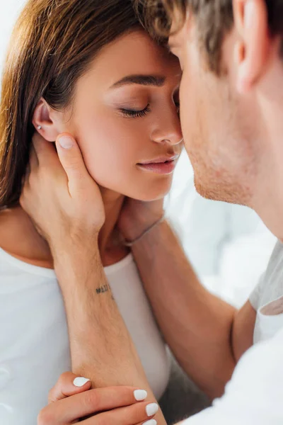 Selective focus of young woman touching boyfriend at home — Stock Photo