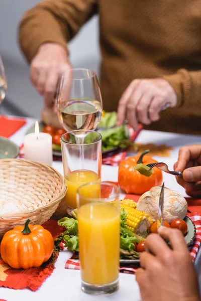 Cropped view of men eating tasty dinner during thanksgiving — Stock Photo
