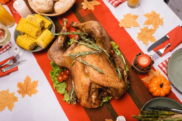 Top view of tasty turkey near thanksgiving dinner and decorations on table — Stock Photo