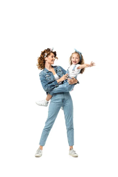 Mother and daughter in denim outfits having fun isolated on white — Stock Photo