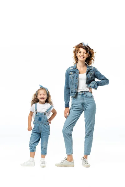 Mother and daughter in denim outfits posing isolated on white — Stock Photo