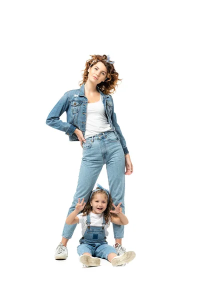 Mother and daughter in denim outfits posing isolated on white — Stock Photo