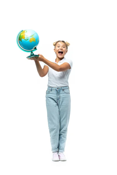 Excited schoolgirl holding globe on white background — Stock Photo