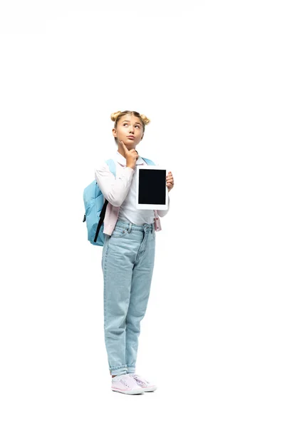 Thoughtful schoolchild holding digital tablet on white background — Stock Photo