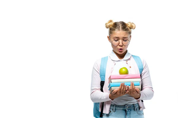 Enfant excité dans des lunettes regardant pomme et des livres isolés sur blanc — Photo de stock