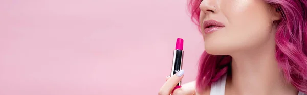 Cropped view of young woman holding lipstick isolated on pink, panoramic shot — Stock Photo