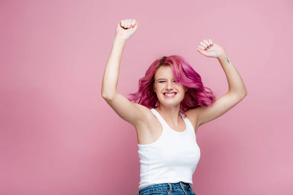 Young woman with colorful hair rejoicing isolated on pink — Stock Photo