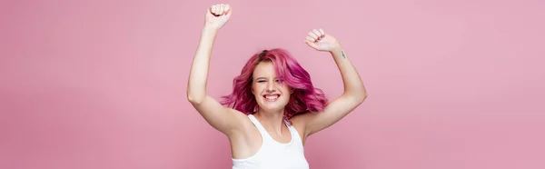 Young woman with colorful hair rejoicing isolated on pink, panoramic shot — Stock Photo