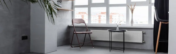 Panoramic shot of home interior with chairs and coffee table near window — Stock Photo