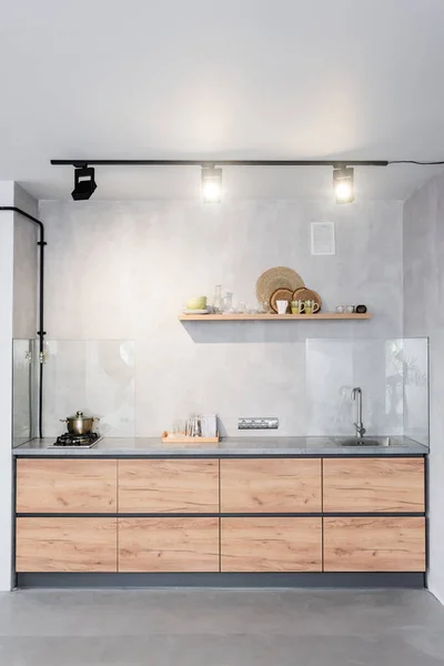 Spacious, minimalistic kitchen with concrete walls — Stock Photo