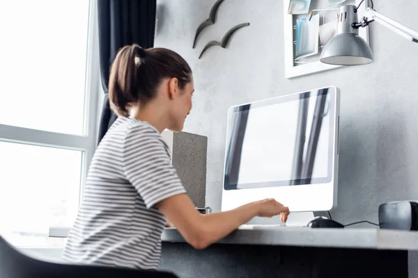 Selective focus of young freelancer working on computer near vr headset at home — Stock Photo