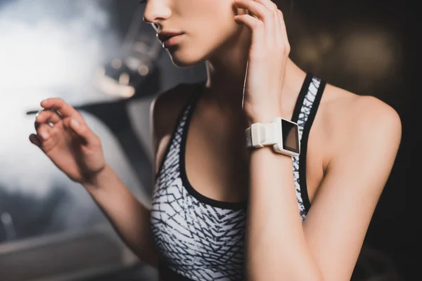 Cropped view of sportswoman with smartwatch in gym — Stock Photo