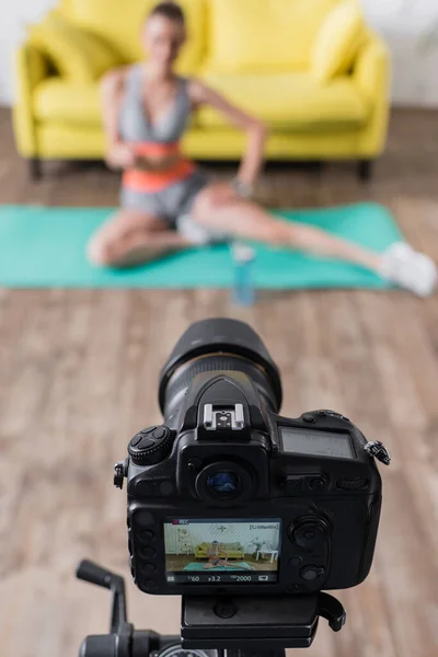 Вибірковий фокус цифрової камери біля тренування молодої жінки вдома — стокове фото