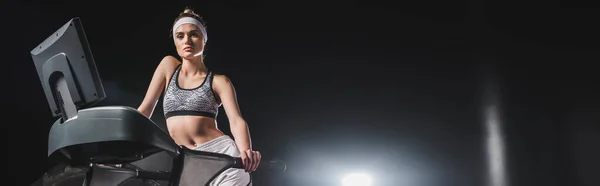 Website header of sportswoman looking at camera on treadmill in sports center — Stock Photo