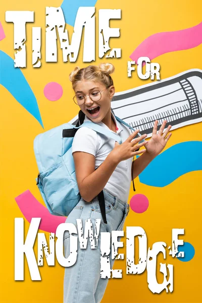 Excited schoolgirl in eyeglasses looking away near paper cut pencil, multicolored elements and time for knowledge lettering on yellow — Stock Photo