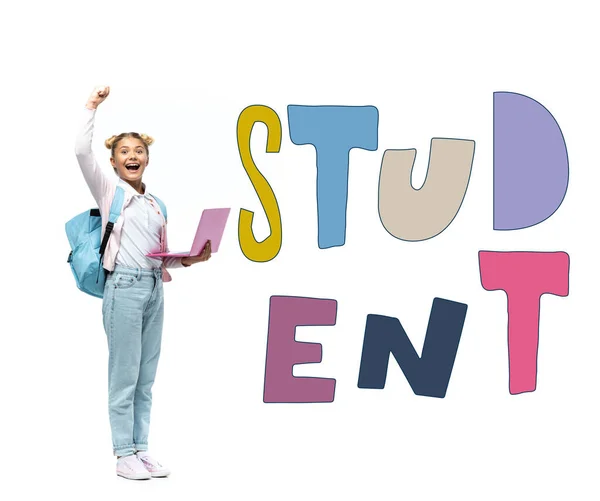 Schoolgirl with laptop and backpack showing yeah gesture near student lettering on white — Stock Photo