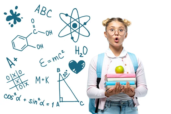 Shocked schoolgirl holding apple and books near math illustration on white — Stock Photo