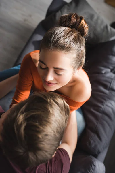 Overhead view of happy woman with closed eyes embraced by beloved man at home — Stock Photo