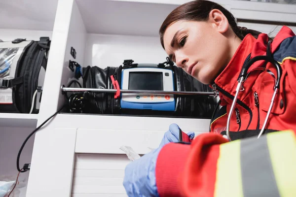 Selektiver Fokus des Sanitäters in Latexhandschuhen bei der Arbeit im Rettungswagen — Stockfoto