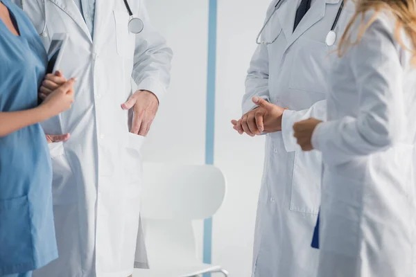 Cropped view of doctors and nurse with digital tablet standing in clinic — Stock Photo