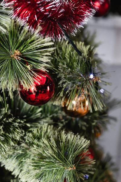 Selective focus of red christmas ball on pine branch — Stock Photo