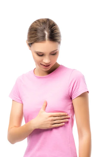 Young woman in pink t-shirt touching breast isolated on white — Stock Photo