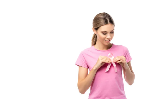 Woman looking at breast cancer awareness ribbon isolated on white — Stock Photo