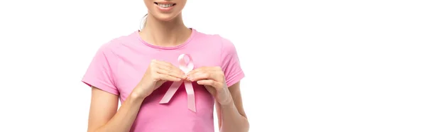 Foto panorámica de mujer joven sosteniendo cinta rosa de conciencia de cáncer de mama aislado en blanco - foto de stock