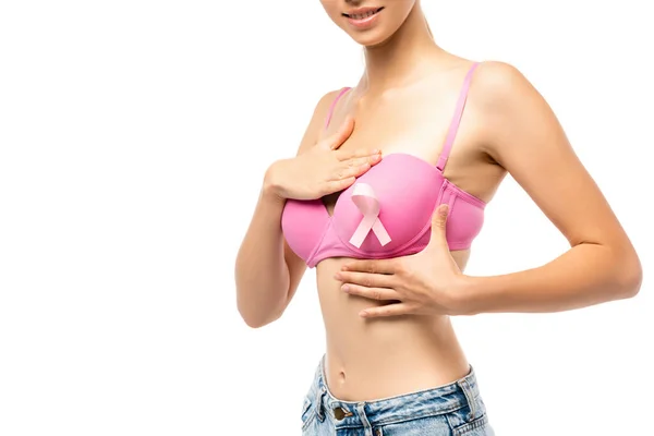 Cropped view of young woman in pink bra and breast cancer awareness ribbon isolated on white — Stock Photo