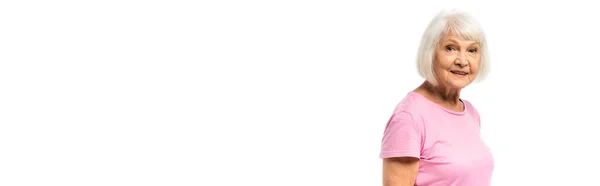 Panoramic orientation of elderly woman in pink t-shirt looking at camera isolated on white — Stock Photo